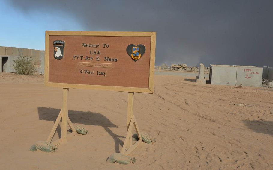 A sign at Qayara Airfield West, Iraq, pictured here on Nov. 21, 2016, welcomes visitors to the Logistics Support Area Pvt. Joe E. Mann, named after a Medal of Honor recipient from World War II. The airfield is a key logistics hub for the campaign to retake Mosul from Islamic State fighters.