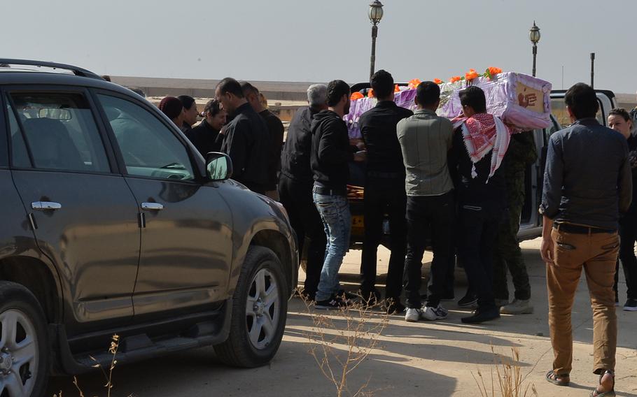 Pall bearers carry the casket of Hadiya Qreo Yohanna at a church cemetery on the edge of the Christian town of Qaraqosh, Iraq, on Nov. 14, 2016. Yohanna fled the town in 2014 as the Islamic State group swept in and died in Irbil in early November.