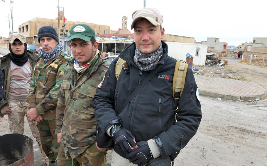 Benoit Kanabus, seen here with members of the Nineveh Plain Protection Units in Qaraqosh, Iraq, on Saturday, Dec. 17, 2016, is a Belgian university professor who volunteered to join the Christian militia in September.