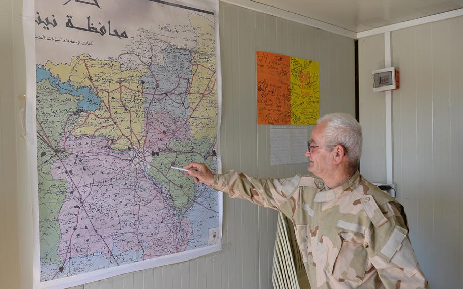 Benham Aboush Almaseh, a former Iraqi army general, points at a map at a training camp for the Nineveh Plain Protection Units near the Christian village of Alqosh on Saturday, July 23, 2016. Almaseh founded the militia to help retake the area from the Islamic State.