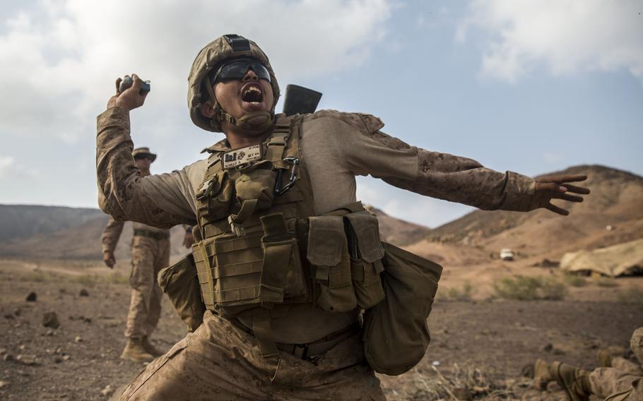 A U.S. Marine with Company C, Battalion Landing Team 1st Bn., 4th Marines, 11th Marine Expeditionary Unit, throws a simulation M67 fragmentation grenade during a mock high-explosive battle drill conducted as part of Exercise Alligator Dagger at Arta Beach, Djibouti Dec. 12, 2016.
