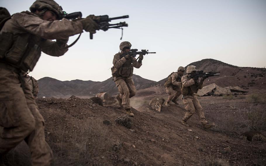 U.S. Marines with the 4th Marines, 11th Marine Expeditionary Unit, rush over a berm during a mock high-explosive battle drill conducted as part of Exercise Alligator Dagger at Arta Beach, Djibouti on Dec. 12, 2016.