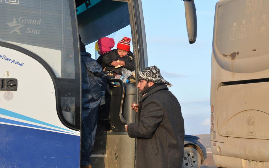 Qusai, an Iraqi man fleeing Mosul with his family, is pictured here on Saturday, Dec. 17, 2016, after receiving a warm sandwich from aid workers at a stop just inside Kurdish-held territory along the highway to the region's capital of Irbil.