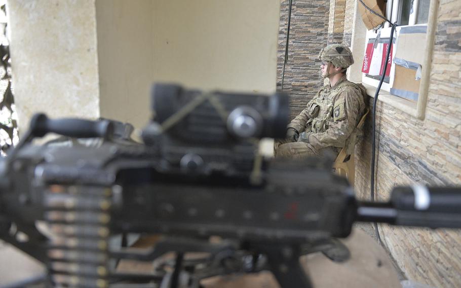 Spc. John Rhodes of Myrtle Point, Ore., is pictured here on Wednesday, Dec. 28, 2016, serving watch duty at a safe house near the forward line of troops in the battle for Mosul, Iraq. Rhodes is one of the soldiers of Apache Company, 1st Battalion, 26th Infantry Regiment, helping secure a tactical base where coalition forces assemble.