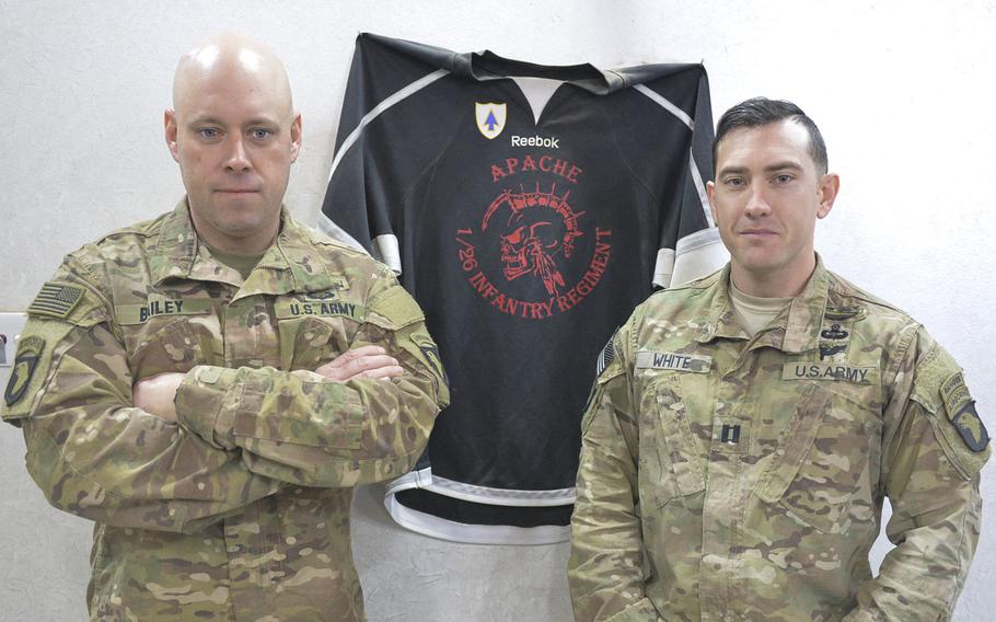 Sgt. 1st Class Brian Bailey, right, and Capt. Jeremy White are pictured on Wednesday, Dec. 28, 2016, with a hockey jersey for Apache Company, 1st Battalion, 26th Infantry Regiment's hockey team at Ft. Campbell, Ky. The jersey decorates a safe house near the forward line of troops in the battle for Mosul, Iraq. Bailey is the company first sergeant and White is the company commander.