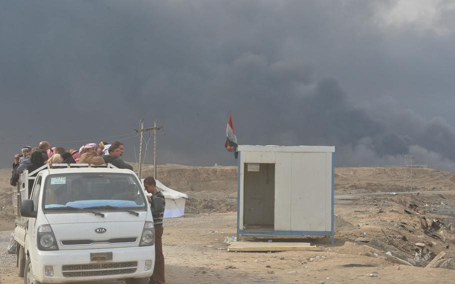 A van full of displaced men is pictured here on the side of the road near Qayara, Iraq, south of Mosul, on Nov. 10, 2016.