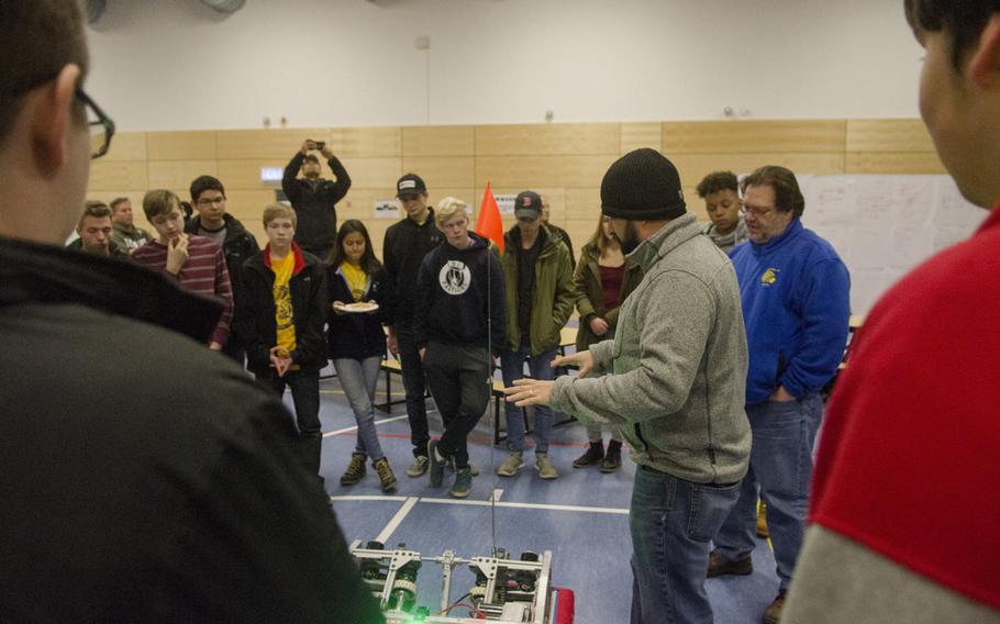 Brian Barnes, a teacher at the DODEA Virtual High School and mentor to the Wiesbaden High School RoboWarriors robotics club, describes the drive train of the robot which will be used in this year's FIRST Robotics Competition during the team's season kickoff party, Saturday, Jan. 7, 2017, in Wiesbaden.