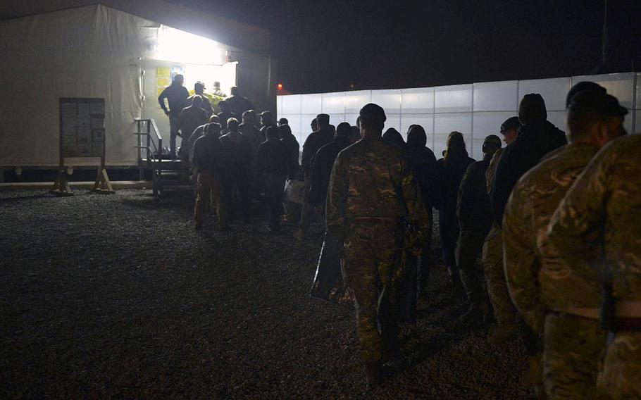 Troops at a coalition base at Irbil International Airport line up for a special screening of ''Rogue One: A Star Wars Story'' on Jan. 6, 2017. The screening of first-run films close to their U.S. release dates is arranged through a partnership between the Walt Disney Co. and the Army and Air Force Exchange Service. 