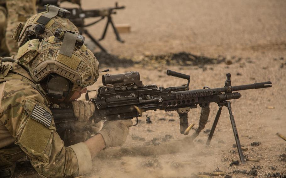 A coalition force member shoots a M-240 Bravo machine gun at a range in Helmand province, Afghanistan, Aug. 16, 2013.
