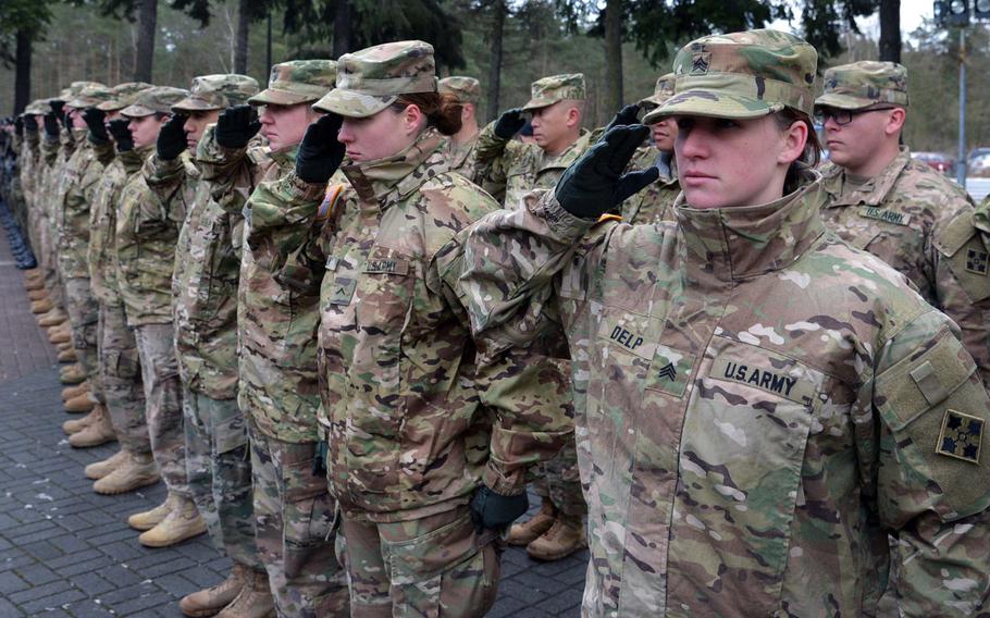 American soldiers of 3rd Armored Brigade Combat Team, 4th Infantry Division, salute during the playing of the national anthem during a welcoming ceremony for them in Zagan, Poland, Thursday, Jan. 12, 2017.