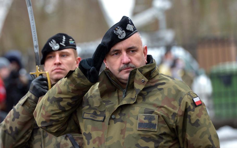 Polish Maj. Gen. Jaroslaw Mika, commander, 11th Armoured Cavalry Division, salutes American troops of the 3rd Armored Brigade Combat Team, 4th Infantry Division, during a welcoming ceremony for the Americans in Zagan, Poland, Thursday, Jan. 12, 2017.