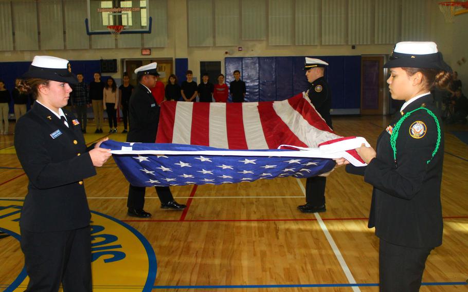 Sigonella Middle/High School Navy Junior Reserve Officer Training Corps Cadets fold an American flag during a ceremony Tuesday, Jan. 10, 2017, at the school in Sicily, Italy. Eighth-graders from the school will head to Washington, where they'll march with the flag in the presidential inaugural parade on Jan. 20.