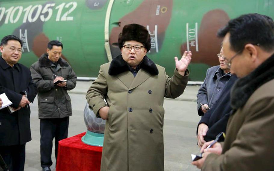 North Korean leader Kim Jong Un, center, is pictured in this undated photo from the state-run Korean Central News Agency.