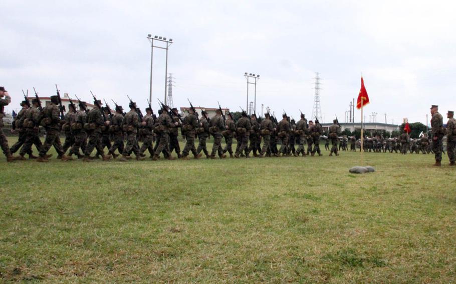 Marines from the nation's only forward-deployed Marine division march past in salute of their outgoing and incoming commanders during a change-of-command ceremony at Camp Courtney, Okinawa, Friday, Jan. 20, 2017. Maj. Gen. Richard Simcock II passed command of the 3rd Marine Division to Maj. Gen. Craig Timberlake.