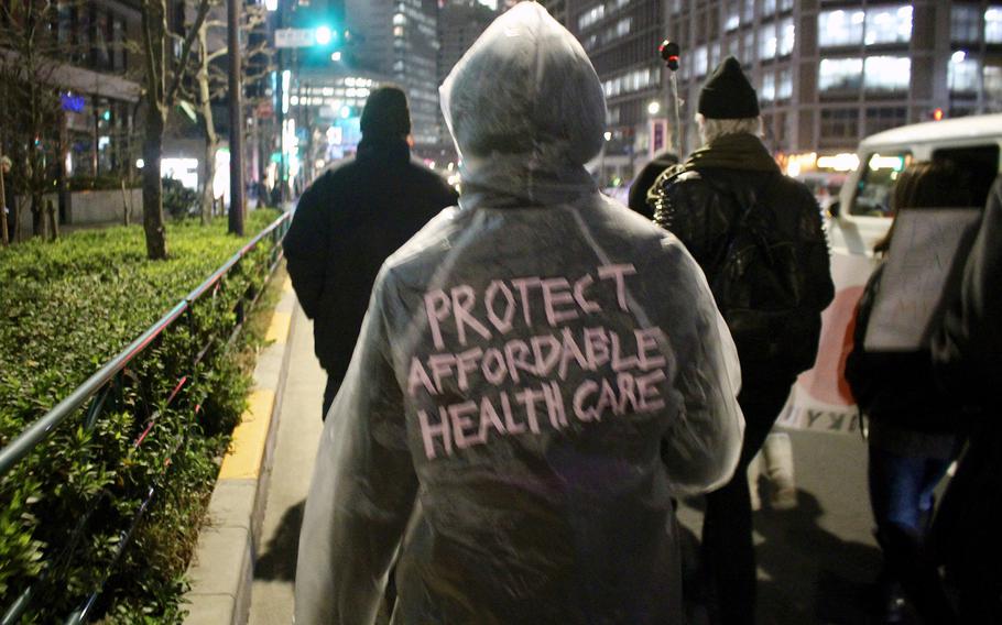 A participant in the Women's March in Tokyo prepared for snow and rain with a protest poncho on Jan. 20, 2017 in central Tokyo.