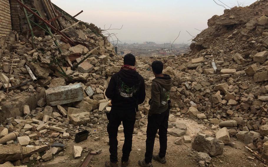 Iraqi special forces troops in Mosul gaze west, toward neighborhoods still held by the Islamic State group, on Saturday, Jan. 21, 2017. 