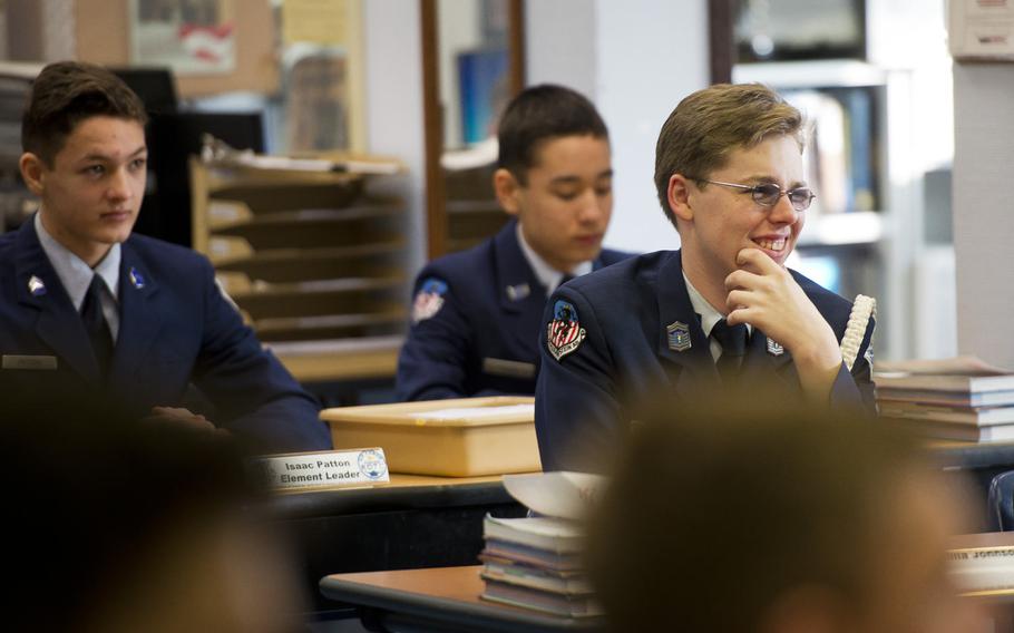 Cole Pretty, right, a Ramstein High School Air Force Junior Reserve Officer Training cadet, listens to Chief Master Sgt. Kaleth Wright speak at Ramstein Air Base, Germany, on Monday, Jan. 23, 2017. According to the study, teacher and parental support, spending time with friends and being physically active make it more likely that a student will be satisfied with life. 