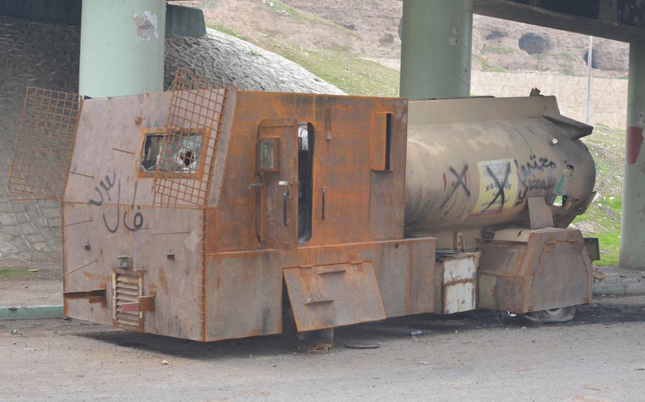 A disabled suicide truck bomb in Mosul on Wednesday, Jan. 25, 2017. A sign on the vehicle, under an overpass near the Tigris River reads: Martyrs' Detachment.