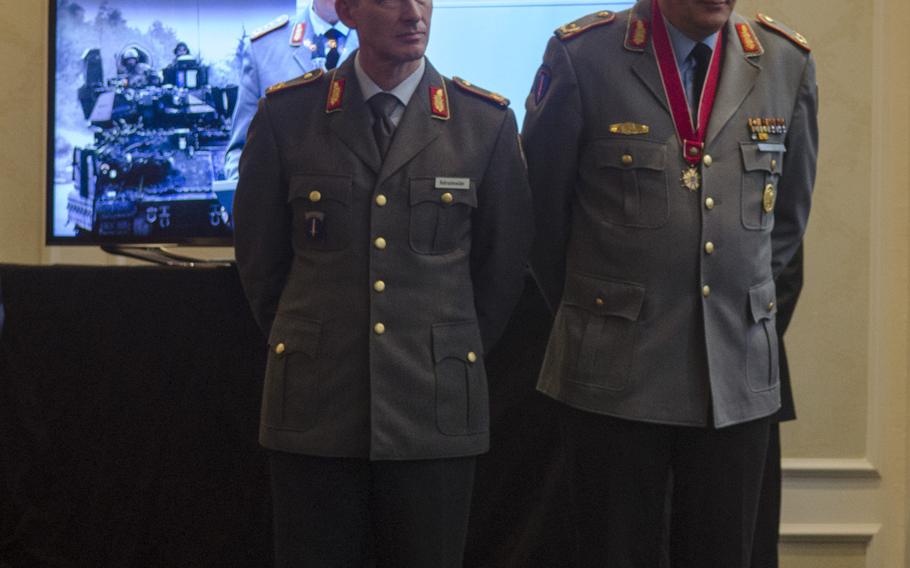 German Army Brig. Gens. Kai Rohrschneider, left, and Markus Laubenthal, stand during a ceremony welcoming Rohrschneider as the new U.S. Army Europe chief of staff and bidding farewell to Laubenthal, the first German to serve in that capacity.
