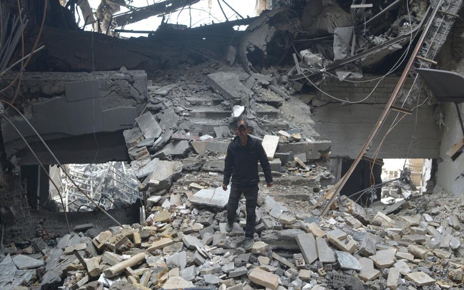 An Iraqi soldier climbs through rubble from an airstrike inside a palace in Mosul, on Wednesday, Jan. 25, 2017