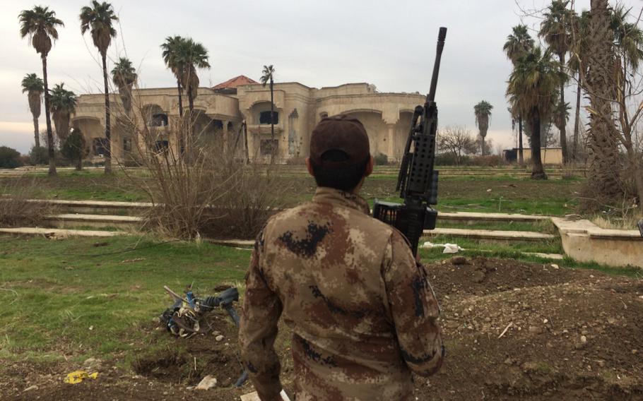 An Iraqi soldier stands guard at a palace in Mosul, Iraq, on Wednesdsay, Jan. 25, 2017.