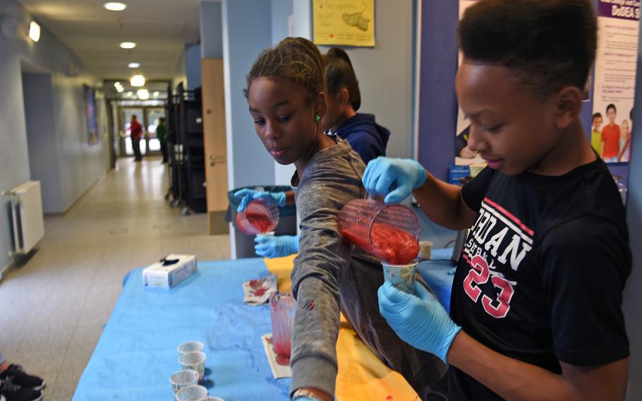 Strawberry smoothies were a big hit at the family wellness night Thursday, Jan. 26, 2017, at Landstuhl Elementary/Middle School in Landstuhl, Germany. Serving up the fruity drinks were members of the youth leadership group, the Torch Club, from, right to left, William Reed, Iyanna Wilson, and Olivia Reed.