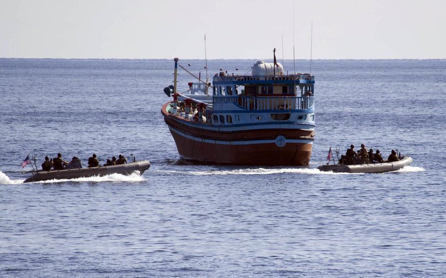 Two rigid-hull inflatable boats from the guided-missile destroyer USS Cole approach an Iranian-flagged dhow that ran out of fuel in the Gulf of Oman, Friday, Jan. 27, 2017.