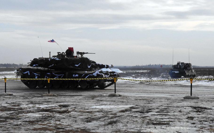 A U.S. Army M1 Abrams tanks speeds to its firing position during the live fire exercise involving Polish and American troops in Zagan, Poland, on Monday, Jan. 30, 2017.