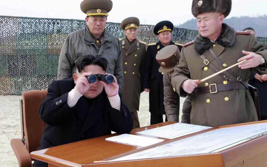 North Korean leader Kim Jong Un sits surrounded by officials in this undated photo from the state-run Korean Central News Agency.