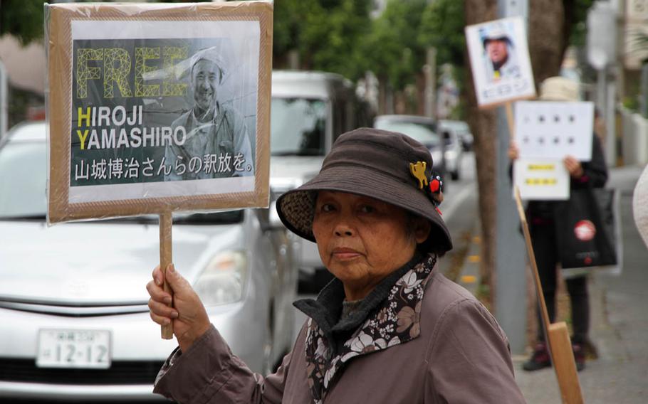Demonstrators call for the release of Okinawan anti-U.S. base protest leader Hiroji Yamashiro in front of Naha District Court Friday, March 3, 2017.