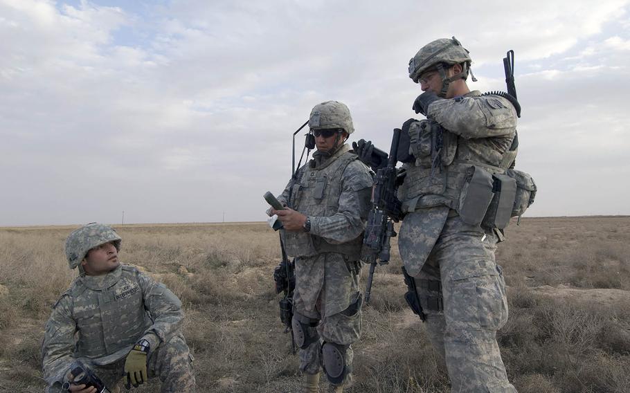 Soldiers coordinate an assault on a house suspected of hiding insurgents outside the village of Samood, in Diyala province, Iraq, on March 3, 2009.