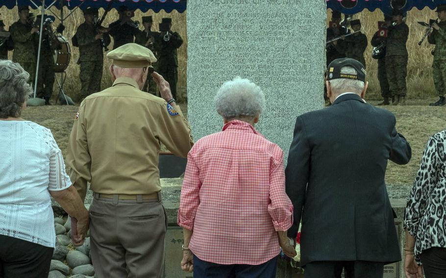Veterans of World War II's Battle of Iwo Jima salute after placing a wreath at a memorial on the island, Saturday, March 25, 2017.