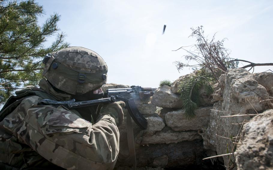 A soldier from Ukraine's 1st Battalion, 28th Mechanized Infantry Brigade, engages opposing force role players during a training exercise at the Yavoriv Combat Training Center near Yavoriv, Ukraine, March 29, 2017.
