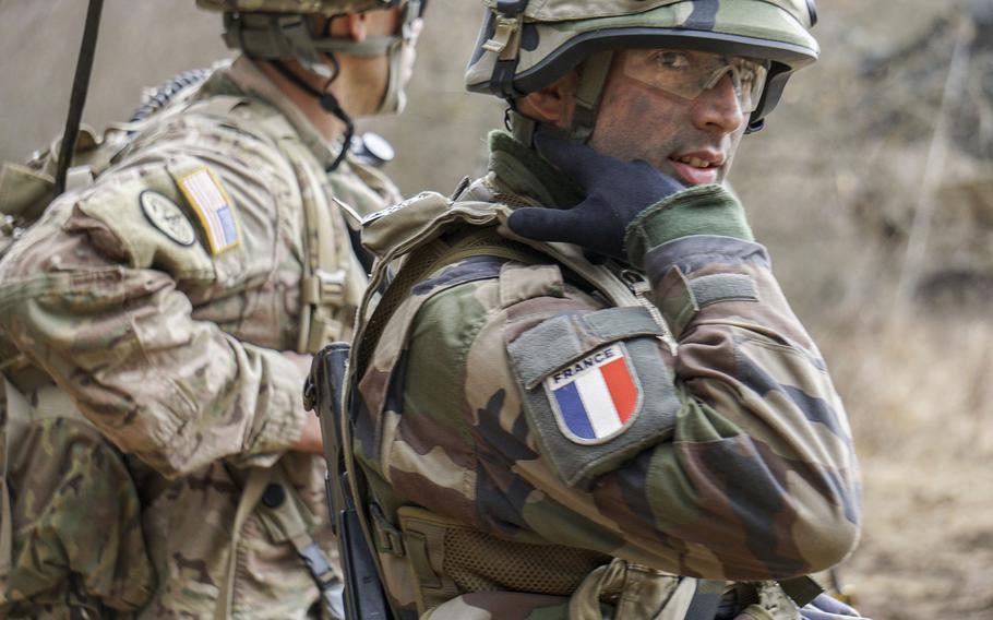 A U.S. soldier from the 173rd Airborne Brigade and a French soldier from the 511th Resupply Transport Regiment work side by side in the Joint Multinational Readiness Center's training area during a quick move of all sustainment materials, March 20, 2017, during Exercise Allied Spirit VI.