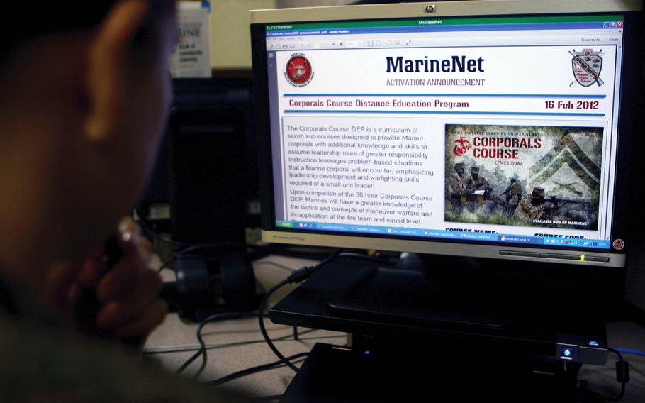 A Marine takes an online course in 2012. The service will cut seven online courses starting next month, according to an internal message obtained by Stars and Stripes.