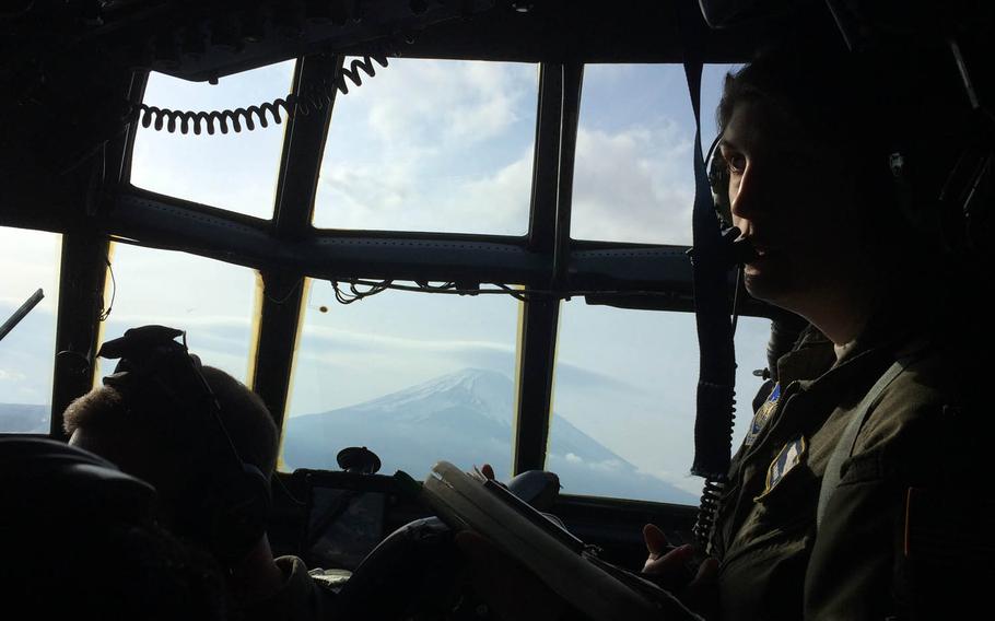 Capt. Sarah Affalter navigates a Hercules C-130H aircraft past Mount Fuji in Japan, Thursday April 20, 2017.