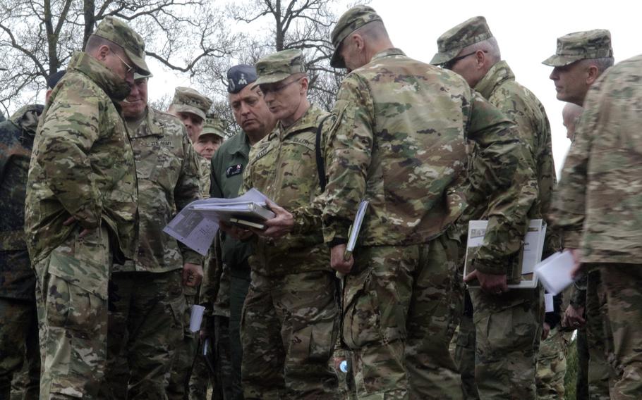 Col. John Baker, center, chief engineer for U.S. Army Europe, goes over plans for railhead expansion with Lt. Gen. Ben Hodges, left, USAREUR commander, and other U.S. and Polish leaders in Powidz, Poland, Wednesday, April 26, 2017.