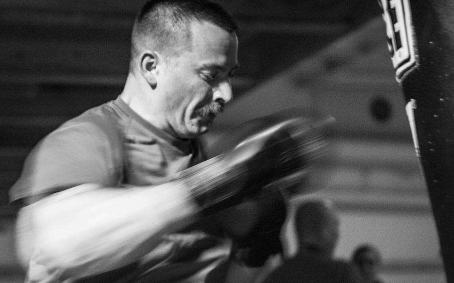Chief Petty Officer Bret Rapier, an aviation electrician's mate on board the aircraft carrier USS George H.W. Bush, boxes to stay in shape during a deployment in the Persian Gulf, April 19, 2017.