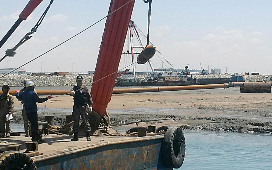 An unexploded Korean War-era bomb is raised from the sea in Pyeongtaek, South Korea, Thursday, April 27, 2017.