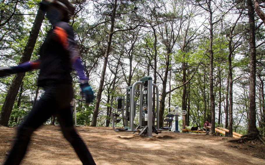 South Koreans hike, exercise and relax just minutes outside of Osan Air Base, South Korea, a presumed ground zero for rocket attacks in case of a war with the North, Tuesday, May 2, 2017.