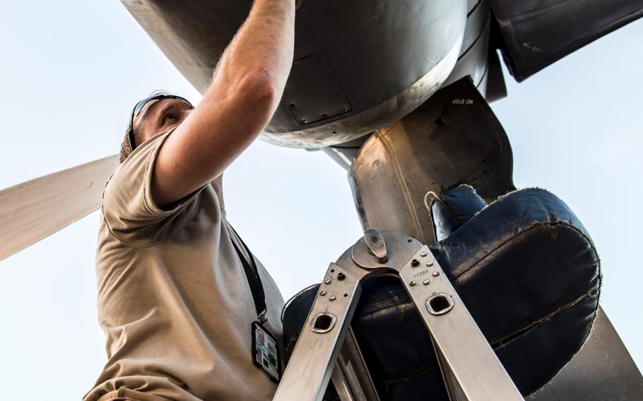 A crew member at an undisclosed location in Southwest Asia ensures the propellers of an EC-130H Compass Call are properly working, March 21, 2017.