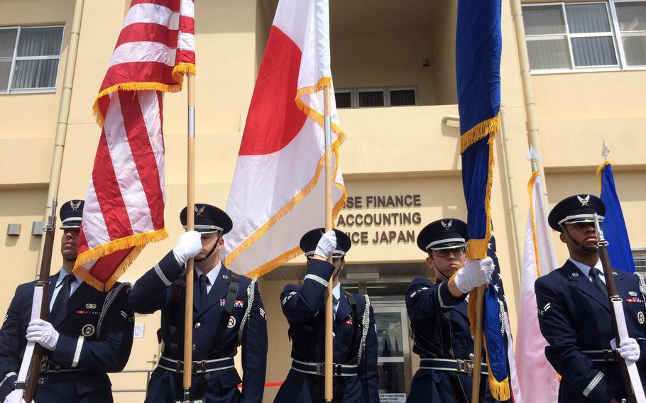 Members of the Yokota Air Base Honor Guard participate in a ceremony for the opening of a new Defense Finance and Accounting Service facility at Yokota Air Base, Japan, Wednesday, May 3, 2017.