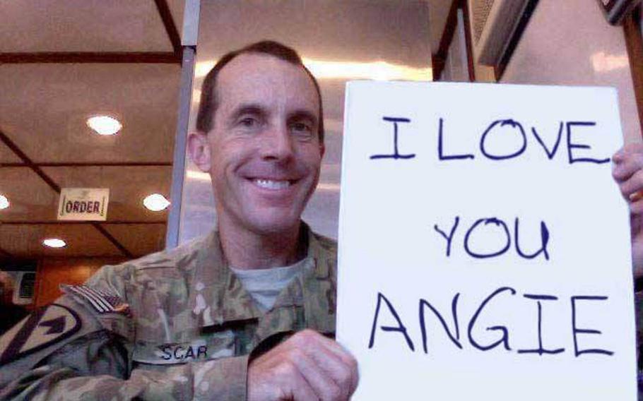 Ken Scar, a reserve Army staff sergeant, has found more than 120 fake Facebook profiles that combine his photographs with various false identities. He was originally holding a copy of Stars and Stripes in this doctored image.