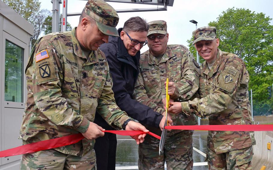 From left, Command Sgt. Maj. Larry Addington, U.S. Army Garrison Wiesbaden command sergeant major, Wolfgang Schnitzer, director of Landesbetrieb Bau und Immobilien Hessen, Col. Todd J. Fish, USAG Wiesbaden commander, and Lt. Col. John H. McNamara, deputy commander, Europe District, US Army Corps of Engineers, officially open the new access control point for USAG Wiesbaden's Hainerberg complex. The new ACP will replace the two current gates when it begins operations May 13.