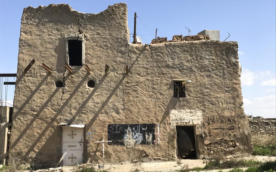This house in the Iraqi village of Batnaya, north of Mosul, pictured here on March 24, 2017, is one of the few still standing. Islamic State fighters had marked it with graffiti. Roughly 70 percent of the structures in Batnaya were destroyed in the fighting to oust Islamic State militants from the village.