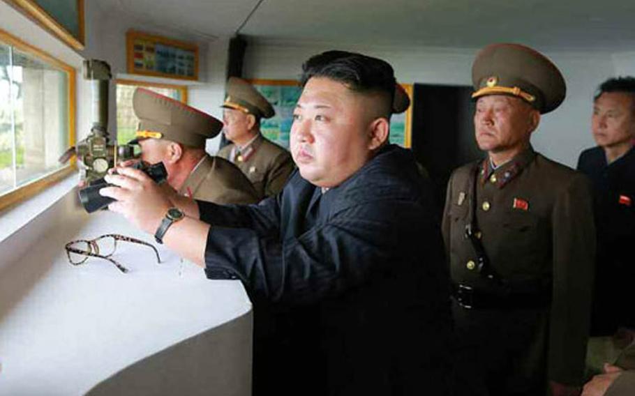 A photo published Friday, May 5, 2017, in North Korea's Rodong Sinmun shows leader Kim Jong Un looking out from an observation post during a visit to troops manning the front lines on islets near the maritime border with South Korea.