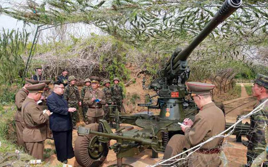A photo published Friday, May 5, 2017, in North Korea's Rodong Sinmun newspaper shows leader Kim Jong Un inspecting equipment during a visit to troops manning the front lines on islets near the maritime border with South Korea.