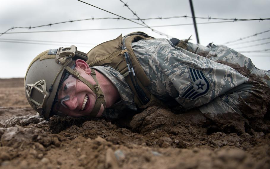 Staff Sgt. Jacob Van Dyke, from the 435th Security Forces Squadron, crawls through the mud during the 435th Contingency Response Group Olympics at Ramstein Air Base, Germany, on Friday, May 5, 2017.