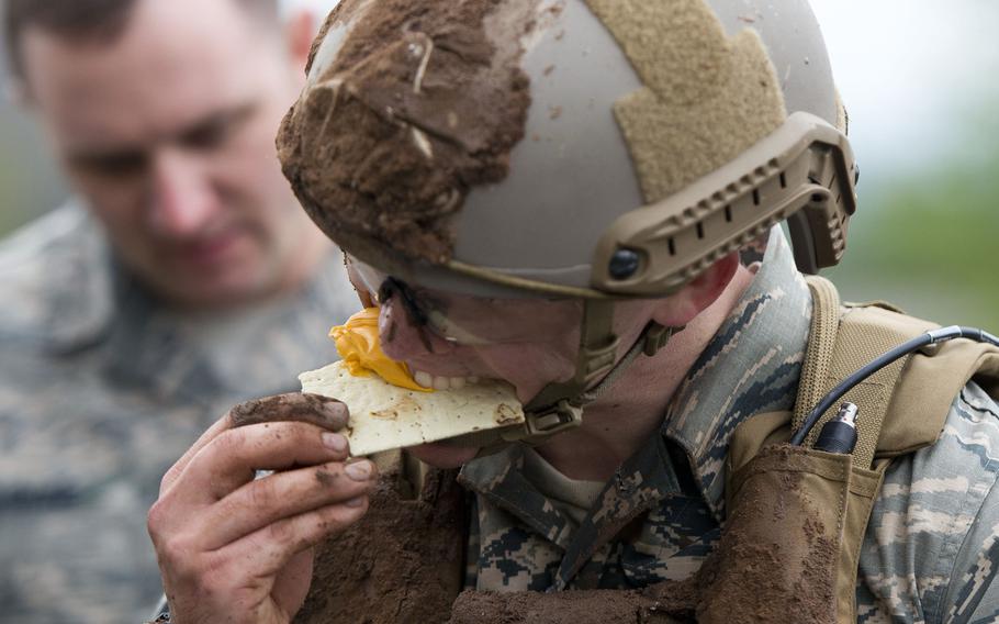 Senior Airman Ryan Daggett, from the 435th Security Forces Squadron, eats cheese and a cracker from a Meal Ready to Eat during the 435th Contingency Response Group Olympics at Ramstein Air Base, Germany, on Friday, May 5, 2017.