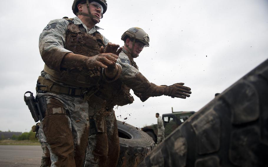 Staff Sgts. Jordan Lucey, left, and Jacob Van Dyke from the 435th Security Forces Squadron, flip a tire during the 435th Contingency Response Group Olympics at Ramstein Air Base, Germany, on Friday, May 5, 2017.
